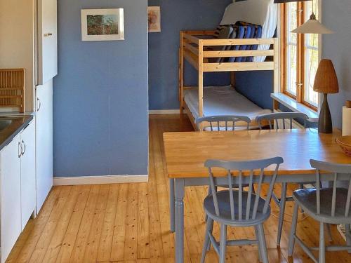 a kitchen with a table and chairs and a bunk bed at 6 person holiday home in Osby-By Traum in Osby