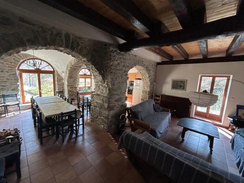 a living room with a couch and a table at Molino di Carpenosa in Molini di Triora