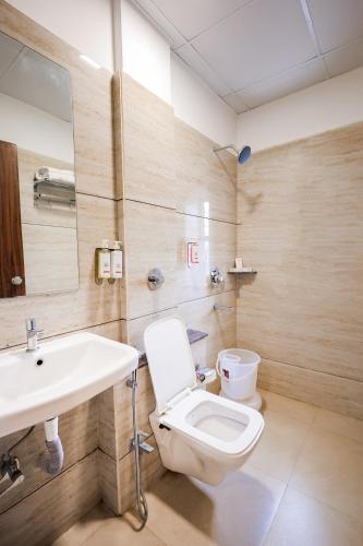 a bathroom with a toilet and a sink at Hotel Konark Nest-Vijay Nagar in Indore