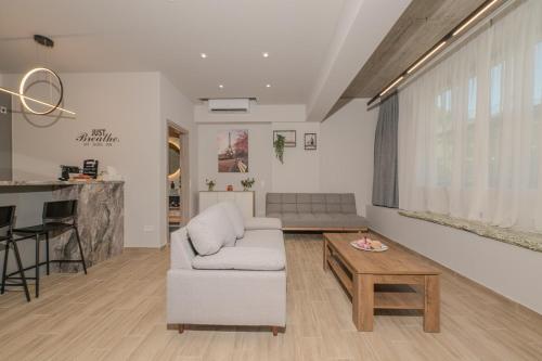 a living room with a couch and a table at Dear Paris Apartment in Piraeus