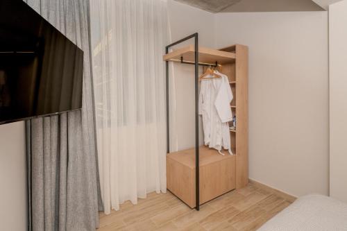 a room with a closet with a white shirt in it at Dear Paris Apartment in Piraeus