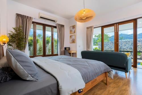 a bedroom with a bed with a large window at Arabella Ao Nang Private Pool Villa in Ao Nang Beach