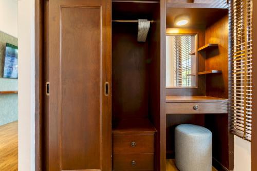 a closet with a wooden cabinet and a mirror at Arabella Ao Nang Private Pool Villa in Ao Nang Beach
