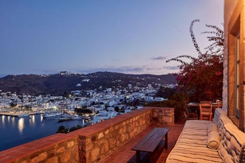 a bench sitting on a wall overlooking a harbor at Patmos Eye Boutique Hotel & Villas in Skala