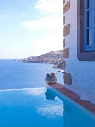 a swimming pool with a view of the ocean at Patmos Eye Boutique Hotel & Villas in Skala