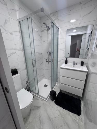 a bathroom with a shower and a toilet and a sink at Mar azul in Puerto de Mazarrón