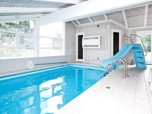 a swimming pool with a slide in a house at Secluded Oasis with Pool - By Traum Ferienwohnungen in Skram
