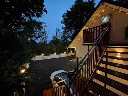 a house with lights on the side of it at Cloud Hills Munnar in Kallar Vattiyar