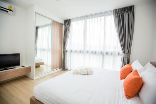 Ένα ή περισσότερα κρεβάτια σε δωμάτιο στο Connext Residence Phuket