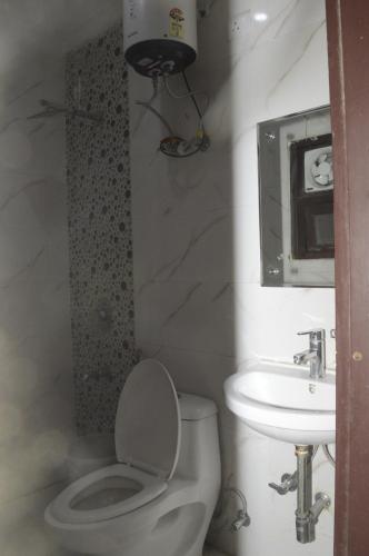 a bathroom with a toilet and a sink at Hotel Airport View at Delhi Airport by Global Group in New Delhi