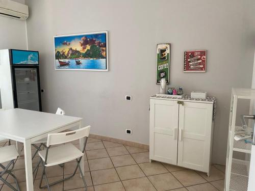 a kitchen with a table and a white table and chairs at Travelershome 7Metri GuestHouse in Ciampino