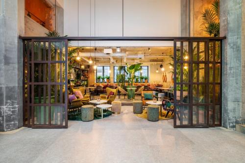 a lobby with doors open to a living room at Hotel Indigo Brussels - City by IHG in Brussels