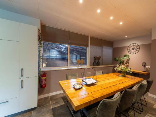 a dining room with a wooden table and chairs at Eibergen s Holiday Haven in Eibergen