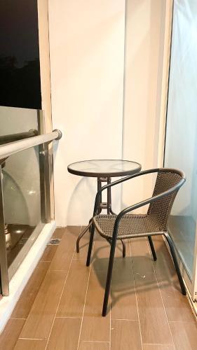 a table and a chair in a room with a window at 2BR Peaceful & Cozy Family Condo in Jakarta