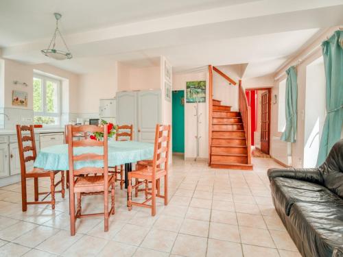 a kitchen and dining room with a table and chairs at Farmhouse in Boncourt with Private Garden in Sainte-Preuve