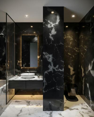 a black bathroom with a sink and a mirror at Hotel Airport View at Delhi Airport by Global Group in New Delhi