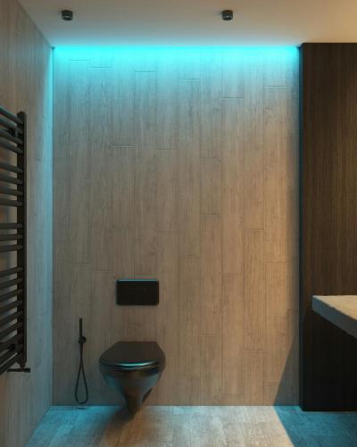 a bathroom with a toilet with a blue light at Hotel Airport View at Delhi Airport by Global Group in New Delhi