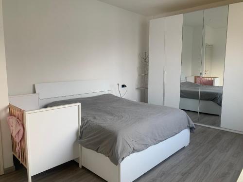 a bedroom with a white bed and a mirror at Top Lake View in Faggeto Lario 