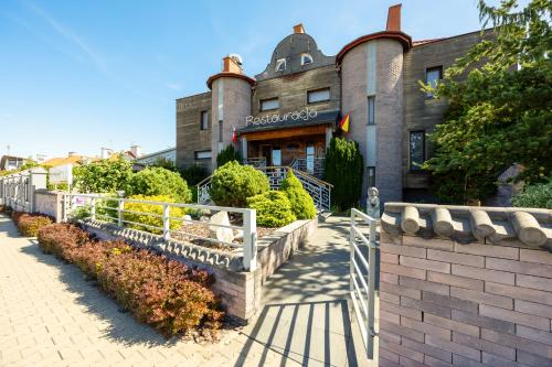 a building with a fence in front of it at Kremowa Residence by Solarento in Warsaw