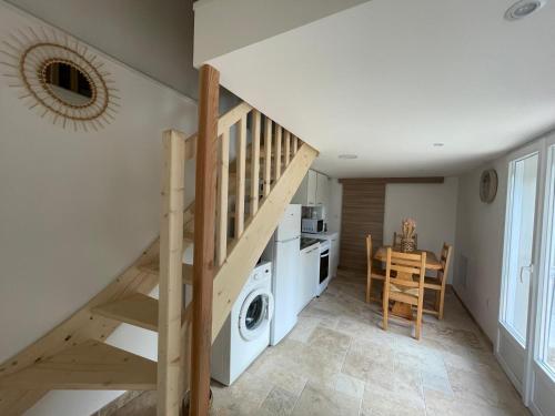 a kitchen and dining room with a staircase and a washing machine at Gite 2 personnes Lac Monteynard - Treffort Isère in Treffort