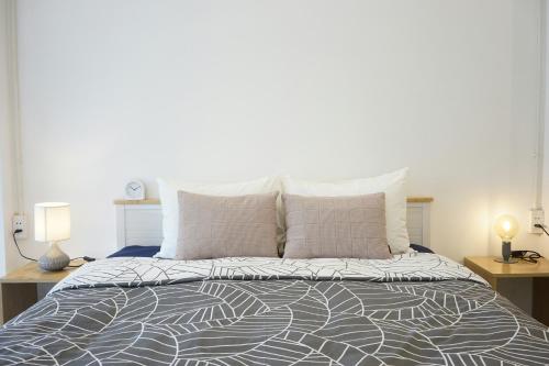 a bedroom with a large bed with two lamps on tables at Hotel Airport View at Delhi Airport by Global Group in New Delhi