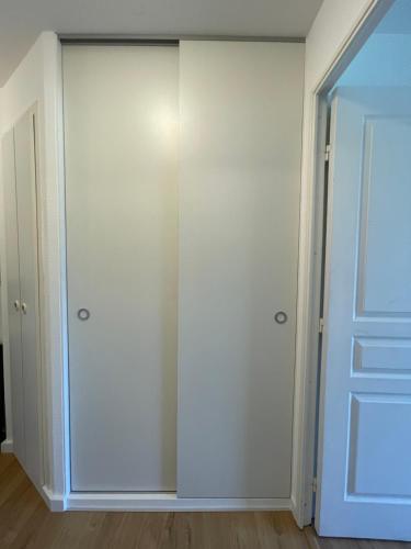 a closet with white walls and a door at Newly renovated flat on the slopes in Avoriaz