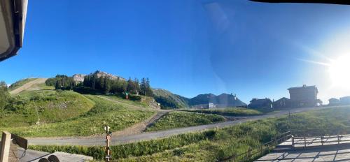 a road on a hill with the sun in the sky at Newly renovated flat on the slopes in Avoriaz