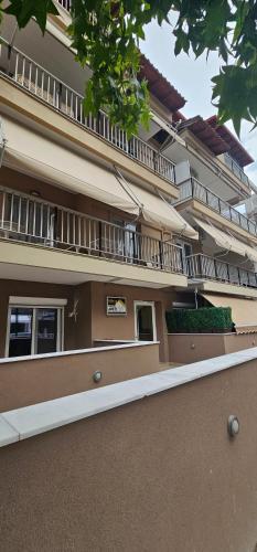 a building with balconies on the side of it at Julsun apartment in Olympiaki Akti
