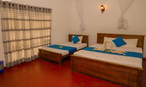 Postel nebo postele na pokoji v ubytování Udawalawe Wild Sfari Resort