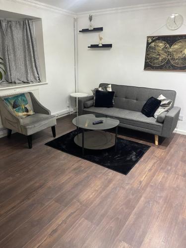 a living room with a couch and a table at Tranquil Thamesmead Treasure - London in Thamesmead