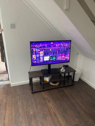 a flat screen tv sitting on a table in a living room at Tranquil Thamesmead Treasure - London in Thamesmead