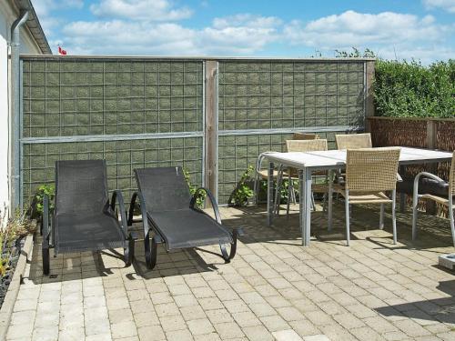 a patio with a table and chairs and a fence at 6 person holiday home in Hejls-By Traum in Hejls