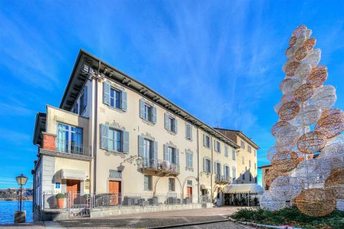 a building with a large sculpture in front of it at Aparthotel Arona in Arona