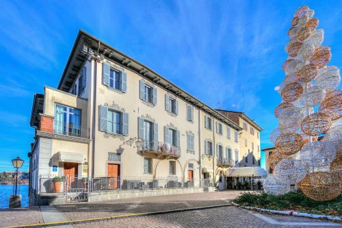 a building with a large sculpture in front of it at Aparthotel Arona in Arona