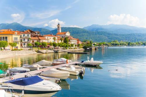 a group of boats docked at a dock on a lake at Aparthotel Arona in Arona