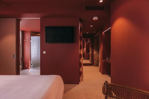a hotel room with a bed and a flat screen tv at Torel Terra Brava in Angra do Heroísmo