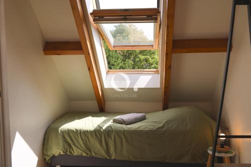 a small bed in a room with a window at COC - La Brise Marine in Wissant