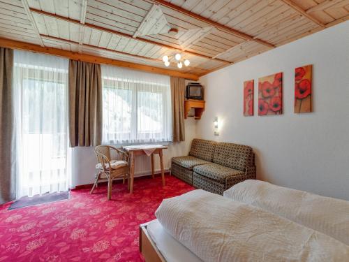 a room with a bed and a couch and a table at Apartment in Kappl near Ski Slopes in Kappl