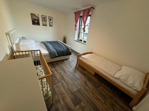 a bedroom with two beds and a window at Chaloupka pod Rabštejnem in Hluboká