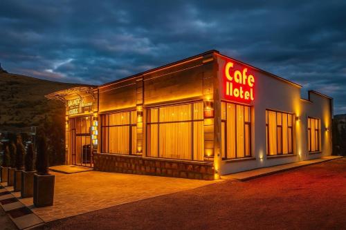 a building with a sign that reads cafe hotel at TIGRAN Hotel by Black & Gold in Goris
