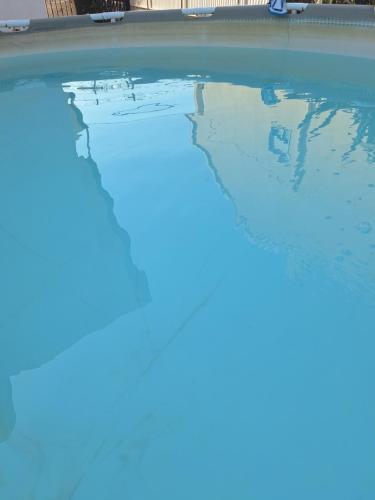a swimming pool with the reflection of the sky in the water at Ângelo in Amora