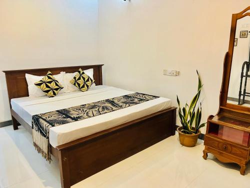 a bedroom with a bed in a room with a chair at Lucky Beach Mirissa in Mirissa