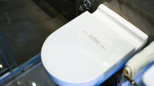 a white toilet with a box on top of it at Bellezza Hotel in Istanbul