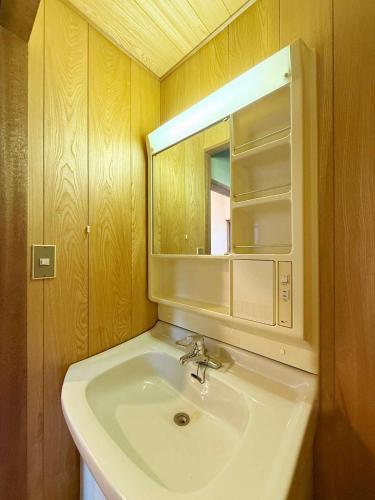 a bathroom with a sink and a mirror at Ryu no Torimichi - Hilltop House Scenic Stay with City Views in Onomichi