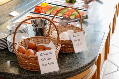 two baskets of eggs and vegetables on a counter at Turmhotel Victoria Davos in Davos