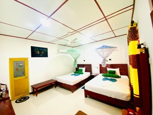 a room with two beds in a room at Panoramic Royal Villa in Sigiriya