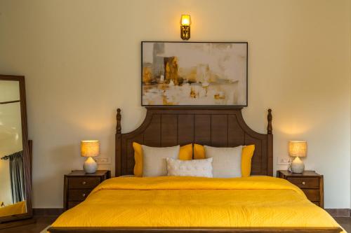 a bedroom with a bed with a yellow bedspread at Villa Nea, Villas By Noor in Aldona