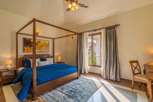 a bedroom with a canopy bed and a window at Villa Nea, Villas By Noor in Aldona
