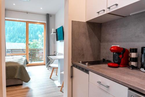 a kitchen with a red appliance on top of a counter at Apartment Bergblick in Ebene Reichenau