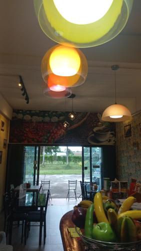 a kitchen with a table full of fruits and vegetables at Amaretto Hostel in Surat Thani